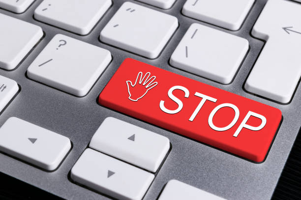 istock Close up view of a Computer notebook keyboard with one red button with word STOP, technology background, empty space for text 813794756