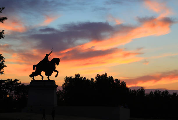 July 7, 2017 - St. Louis, Missouri - The sunset over the Apotheosis of St. Louis statue of King Louis IX of France, namesake of St. Louis, Missouri in Forest Park, St. Louis, Missouri.