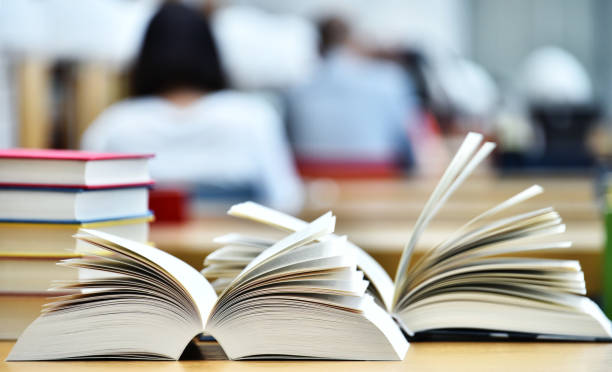 istock Books lying on the table in the public library 813799296