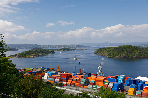 Oslo, Norway - July 02, 2017:  Southern view from Oslo's Ekeberg Park. In front the colorful container terminal, in the background the sea landscape of the fjord south of Oslo.