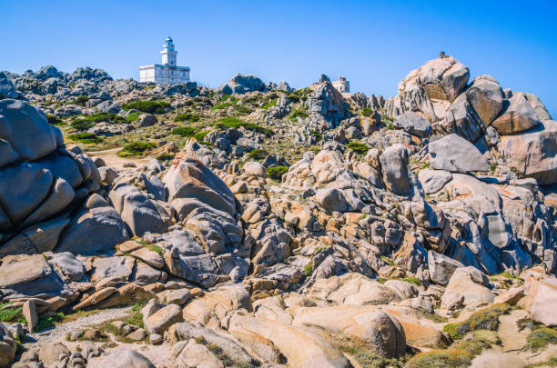 istock White lighthouse of Capo Testa in north Sardinia, Hudge Granite Rocks in front 813804036