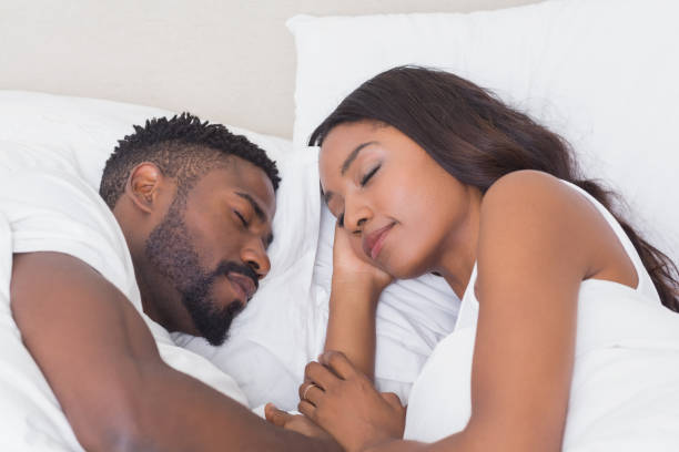 istock Happy couple sleeping in bed together 813806200