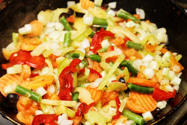 istock Assorted vegetables are fried in a frying pan 813819056