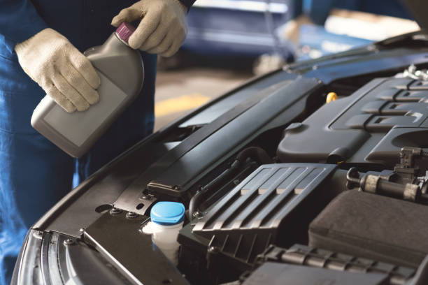 istock Excellent skilled mechanic using motor oil 813821578