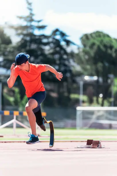 Photo of Disabled man athlete training with leg prosthesis.