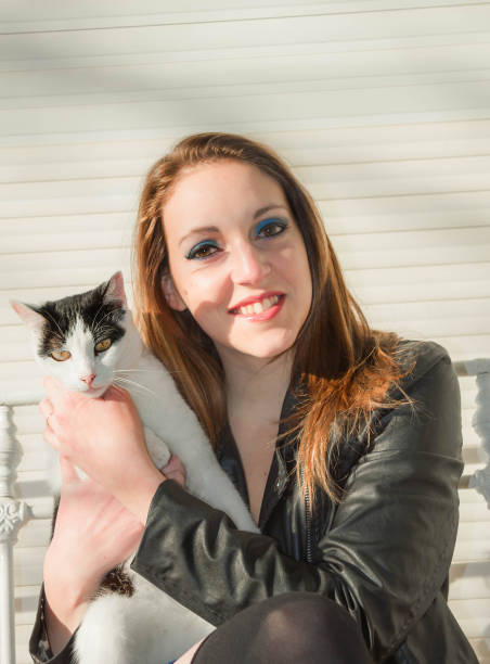 istock woman looking to the kitty 813830714