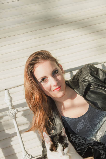 istock woman looking to the kitty 813830744