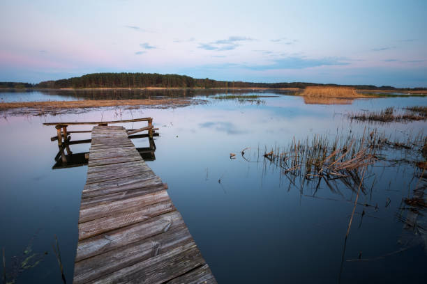 istock Old Wooden pier on the lake. Long exposure. 813837154