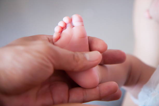 istock New born baby feet 813843738