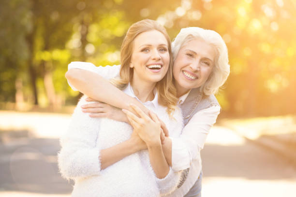 istock Friendly woman enjoying walk with pensioner in the square 813847568