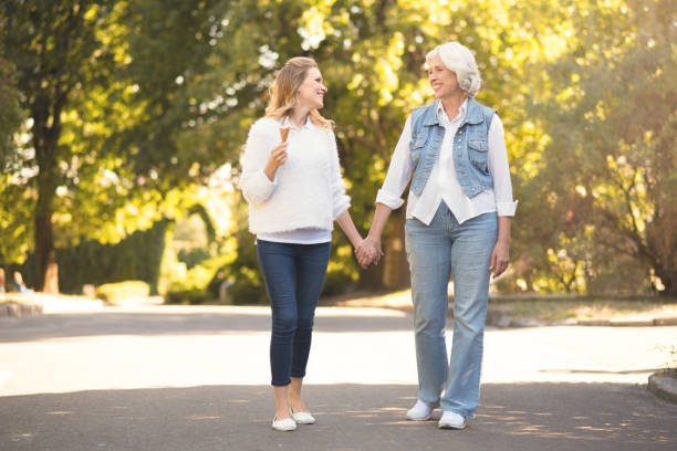 istock Active old woman walking with daughter outdoors 813857070
