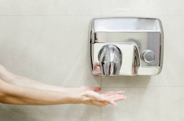 Woman dries her hands