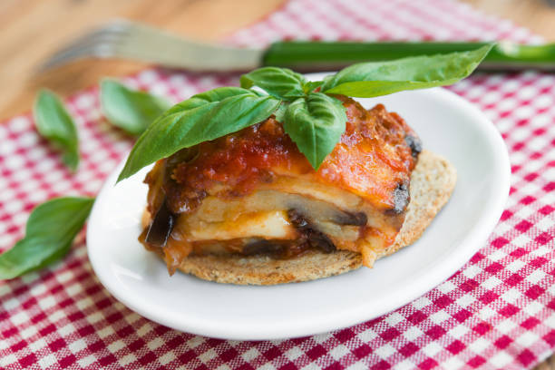 Eggplant parmigiana portion with tomato sauce, mozzarella and fresh basil