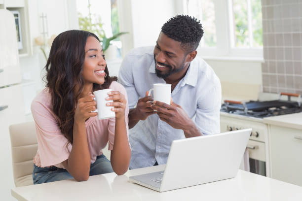 istock Happy couple using laptop together 813859648