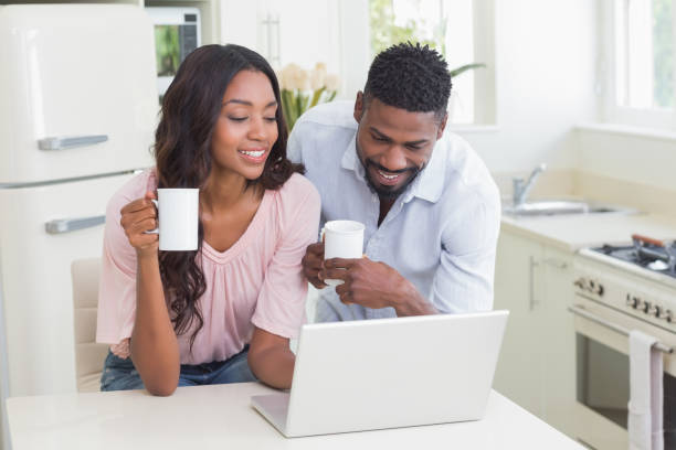 istock Happy couple using laptop together 813859742