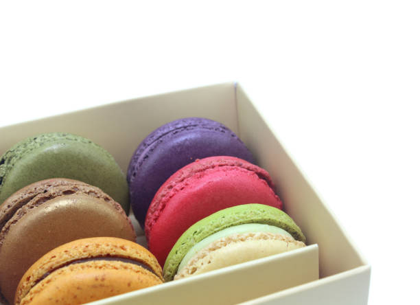 istock Tasty colorful macaroon in box paper on white background 813859910