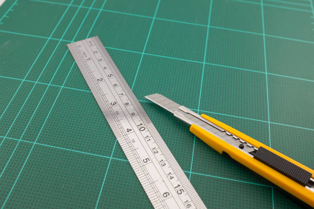 istock Cutter and steel ruler on cutting pads 813872420