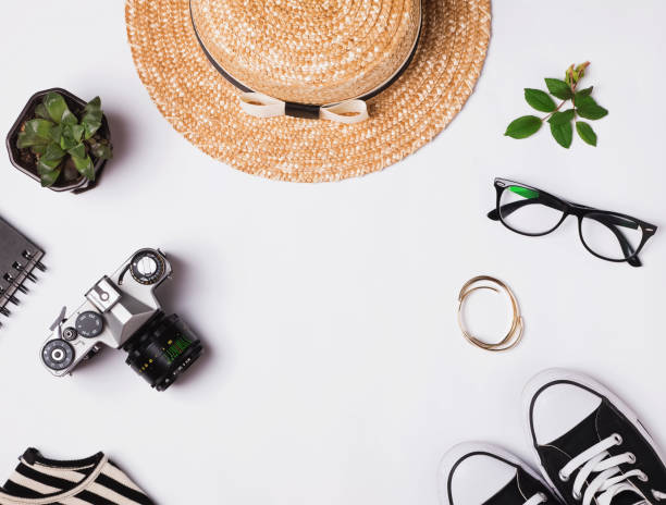 istock Straw hat, sneakers, vintage camera and other outfit on white background 813872756