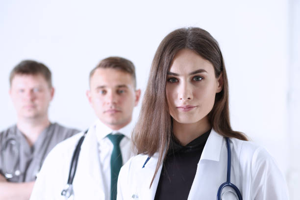 istock Group of medics proudly posing in row and looking in camera 813872992