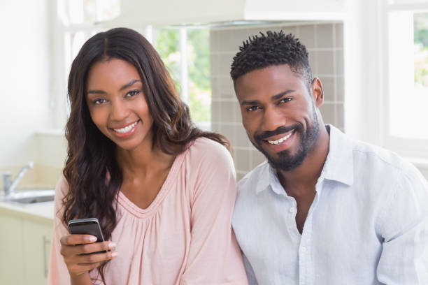 istock Happy couple using their phones at breakfast 813886942