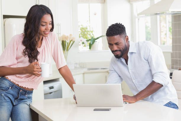 istock Happy couple using their laptop at breakfast 813888786