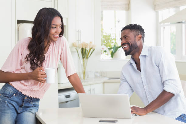 istock Happy couple using their laptop at breakfast 813888824