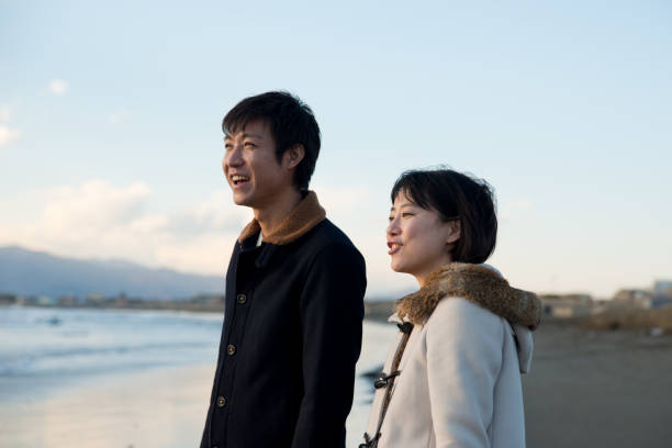 istock couple walking on the beach 813888996