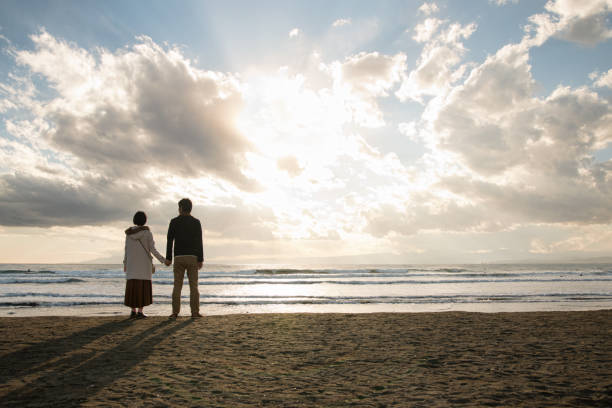 couple walking on the beach Couple dating in Enoshima Island, a famous tourist spot in Japan fujisawa kanagawa photos stock pictures, royalty-free photos & images