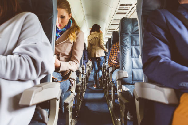 istock Interior of airplane with people sitting on seats 813891870