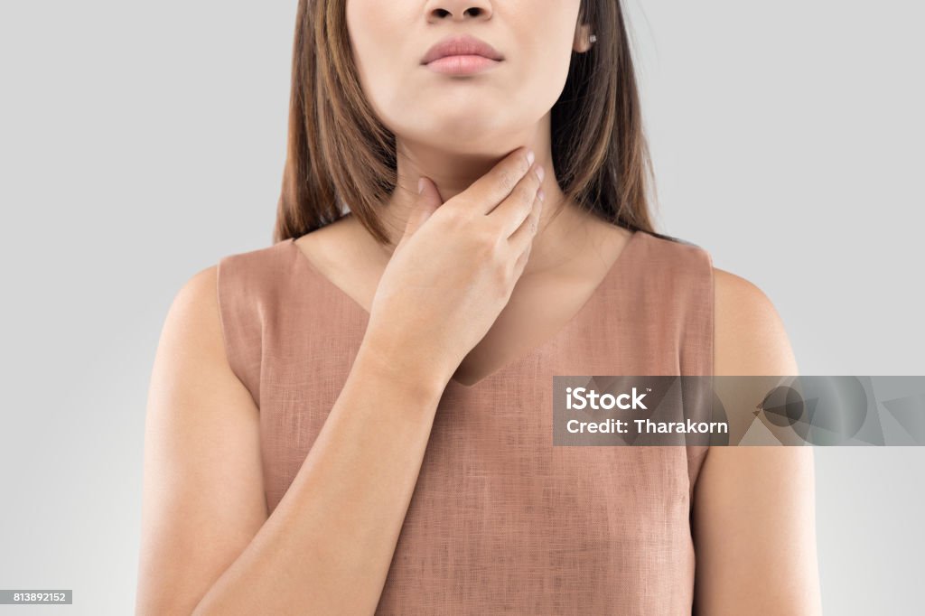 Sore throat woman on gray background Thyroid Gland Stock Photo