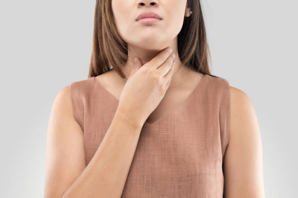 Sore throat woman on gray background stock photo