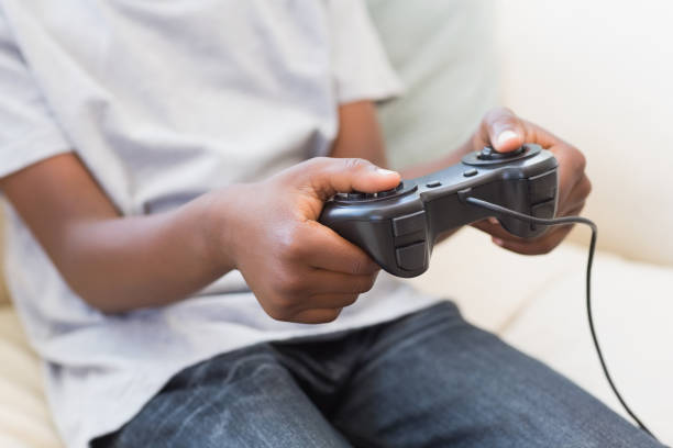 istock Little boy playing video games 813895478