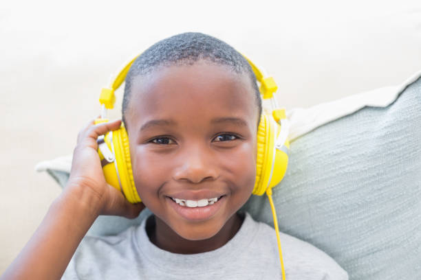 Little boy listening to music on the couch Little boy listening to music on the couch at home in the living room 9 stock pictures, royalty-free photos & images