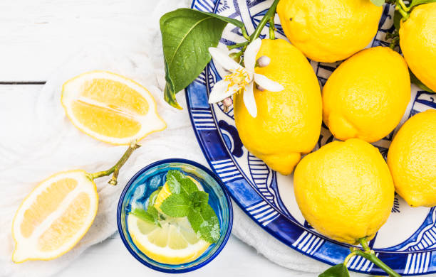 Fresh lemons and glass with infused water.