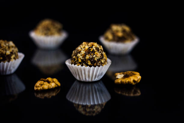 Walnut truffle with mirror reflection and walnuts