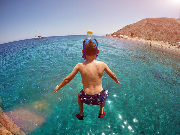 Close-up little child is swimming in the sea