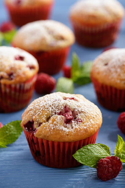 istock Sweet homemade raspberry muffins on wooden table. 813902490