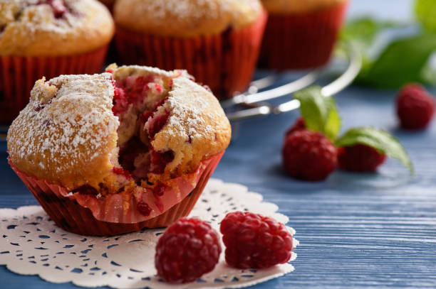 istock Sweet homemade raspberry muffins on wooden table. 813904578