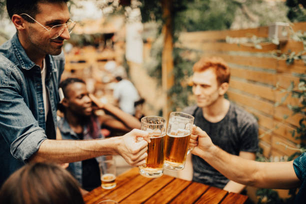 istock Group of colleagues go to pub after work to grab a beer 813905714