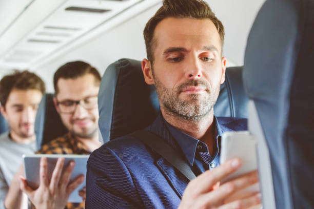 istock Businessman travelling by flight using smart phone 813907022