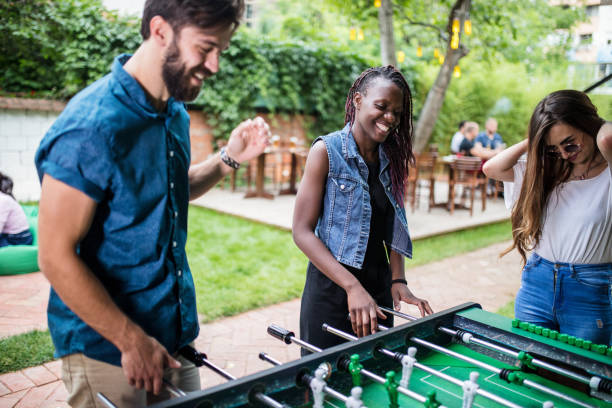 istock Happy friends playing foosball at the pub 813907238