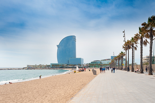 Barcelona, Spain - May 2017: Sandy Barceloneta beach with W hotel on a background
