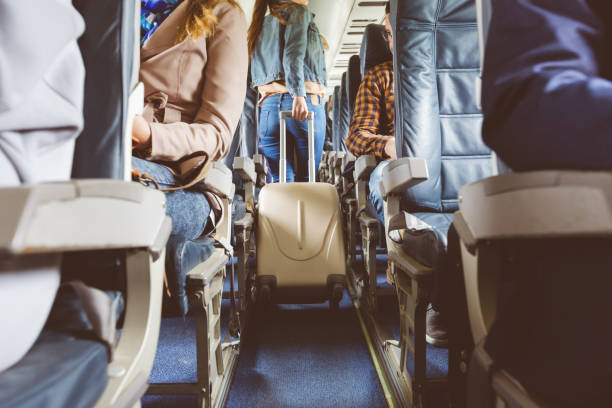 istock Interior of airplane with people sitting on seats 813907890