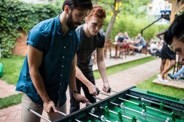 istock Men playing foosball at the pub 813910058