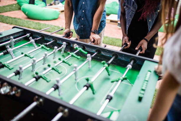 istock People playing foosball at the pub 813911076