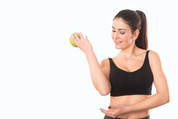 istock Young caucasian woman holding apple. 813915706