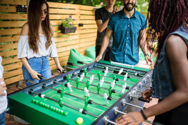 istock Two girls playing foosball at the pub 813915752