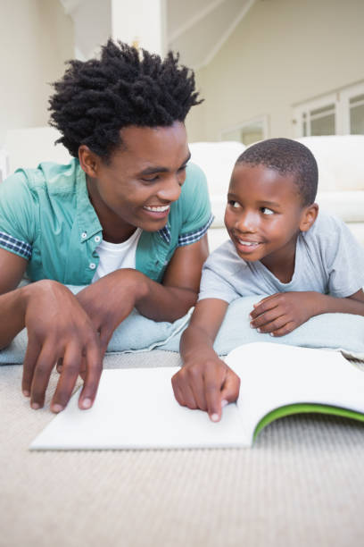 istock Father and son reading on the floor 813915838