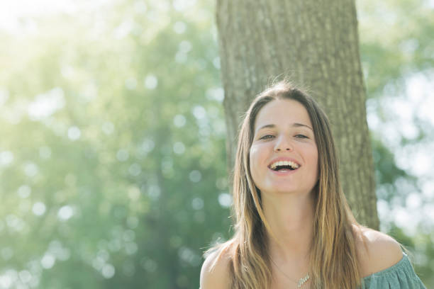 istock smiling portrait outdoors young woman 813919324