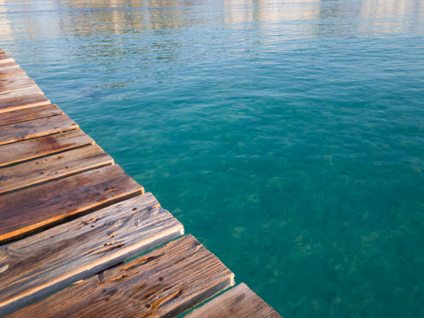 istock Rustic wooden boards pier, summer vacation background 813927262